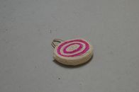 High angle of straw bag with bright round elements and handles on concrete surface