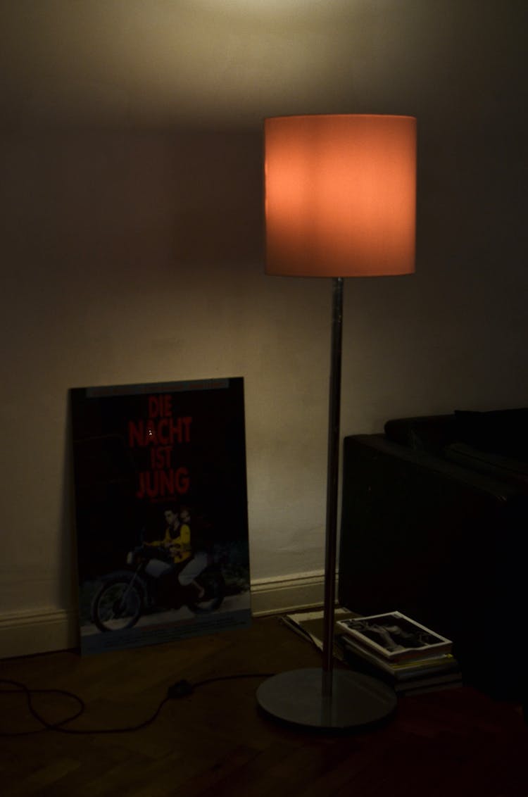 Floor Lamp Near Poster In Room