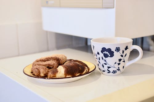 Mug of coffee and croissants on table