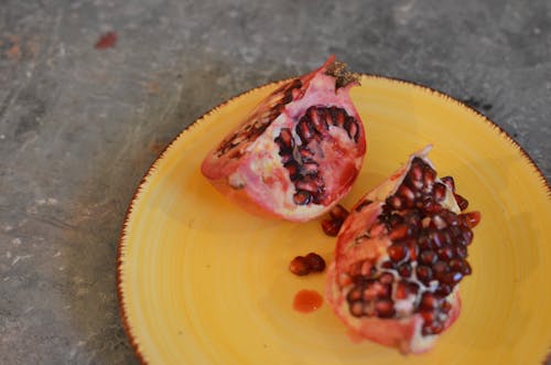Free Delicious slices of pomegranate on plate Stock Photo