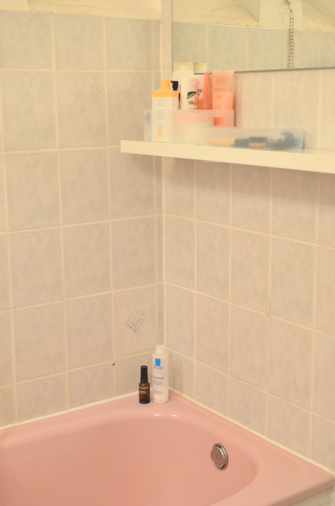Personal skincare and body-care products arranged in a clean bathroom