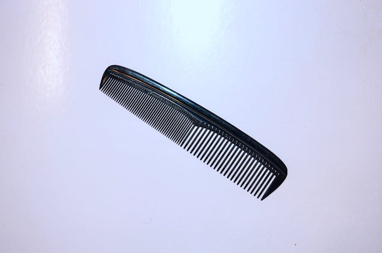 Comb Placed On White Surface