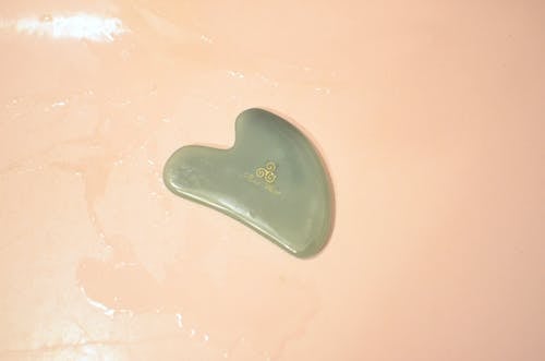 Jade Gua Sha tool in bathtub