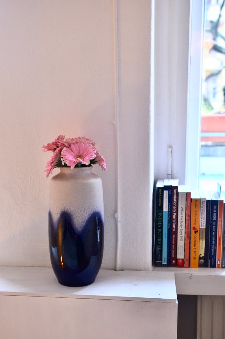 Pink Flowers In Vase On Shelf