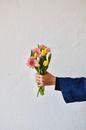 Crop person with bouquet of flowers