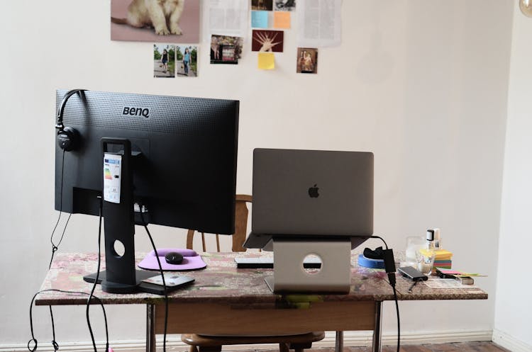 Laptop And Stationary Computer On Table