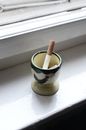 Ashtray with cigarette in windowsill