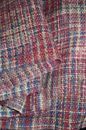 From above of knitted boucle fabric with checkered ornament for sewing warm apparel