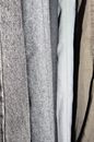 Collection of various clothes made of different fabric and sizes hanging in row