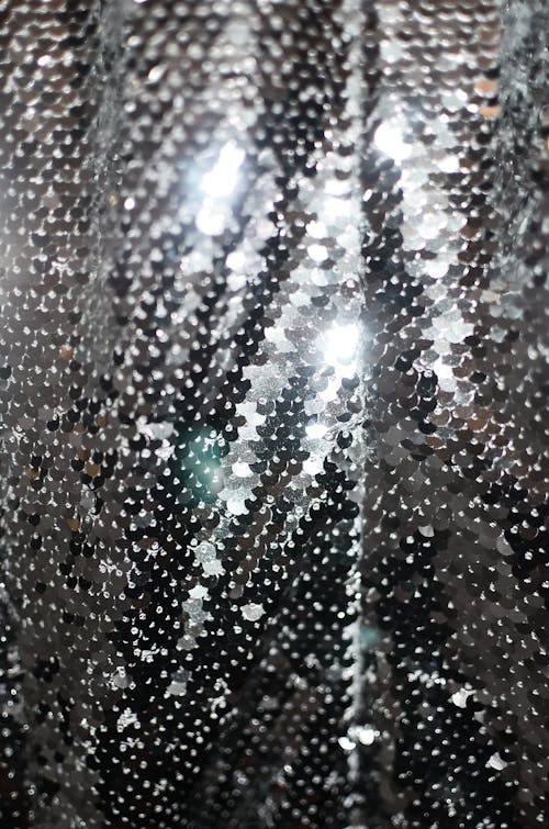 Full frame abstract background of shiny metallic surface of cloth covered with sequins