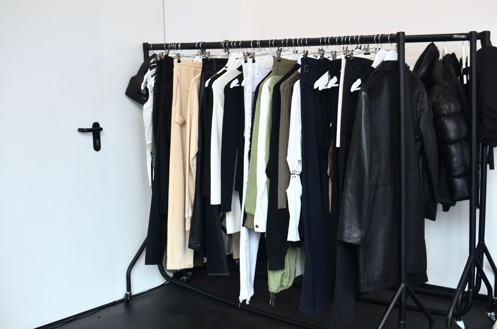 Organized clothing rack with garments and tops without people