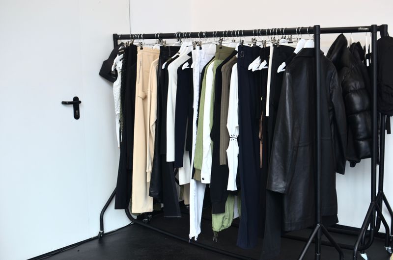 Knitwear and outerwear on a clothing rack