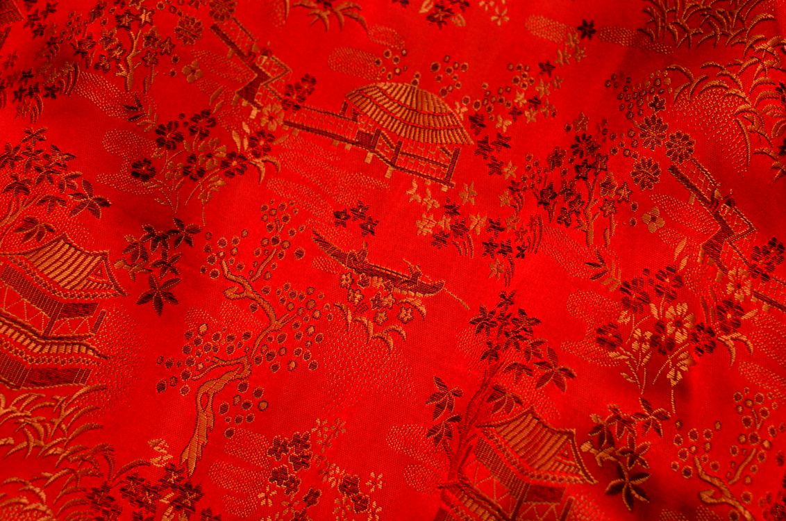 Red cloth with various ornamental elements · Free Stock Photo