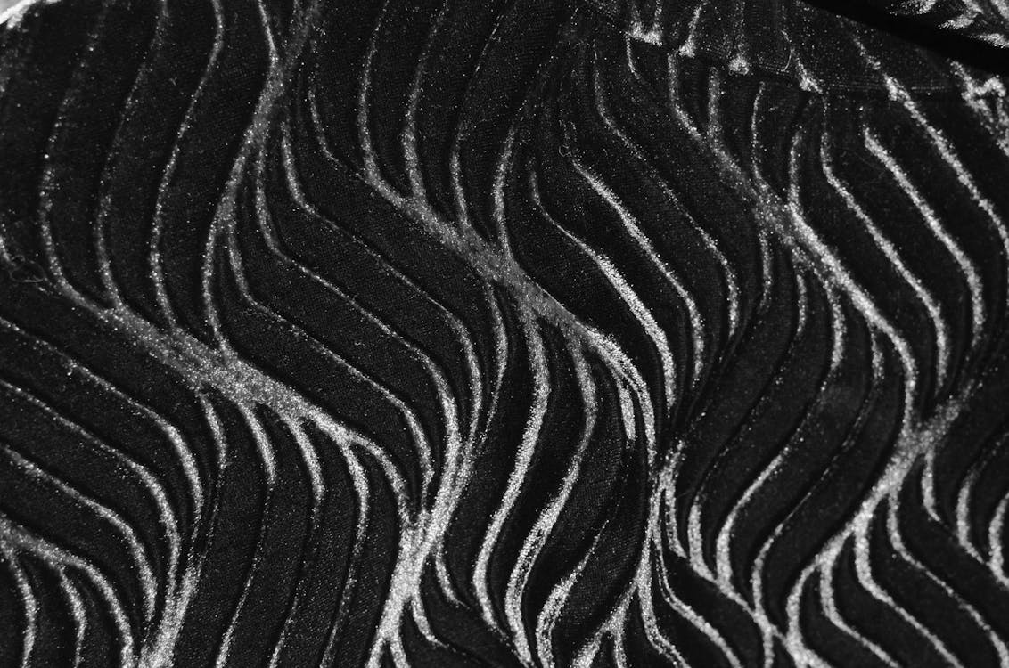 Black and white of seamless abstract background with long wavy patterns creating curve ornament on thick textile with creative design