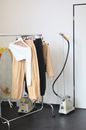 Rail with garments near steamer