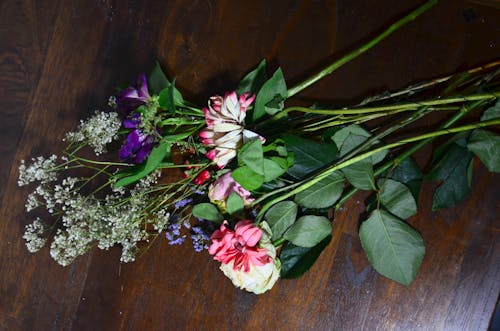 Various flowers on wooden surface