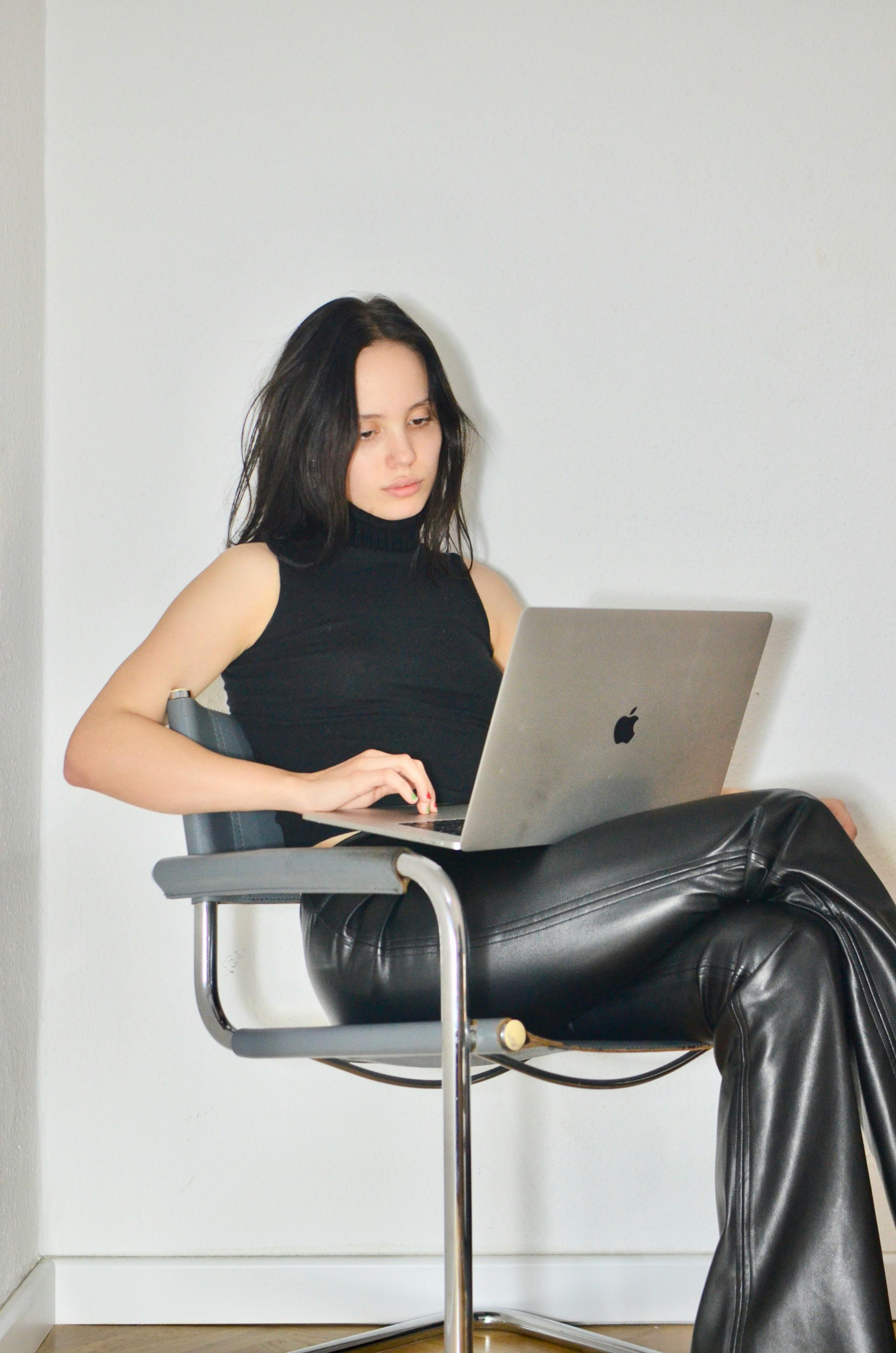 thoughtful woman working on laptop