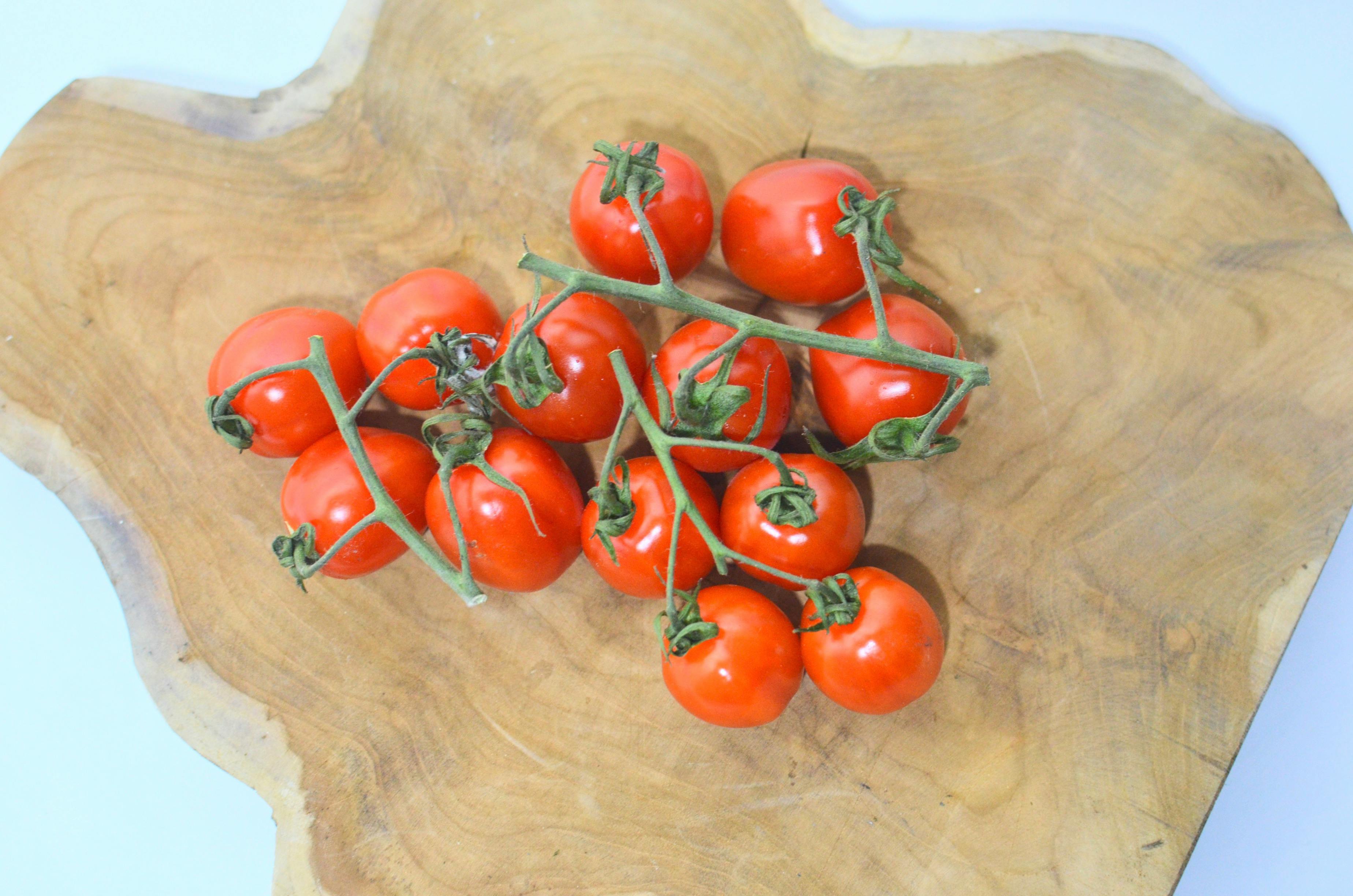 ripe tomatoes on cutting board