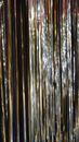 Bright shiny silver smooth tinsel hanging straight in rows for decoration during New Year holidays
