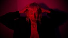 Expressive Woman Screaming on a Dark Room
