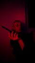 Woman with knife in dark room