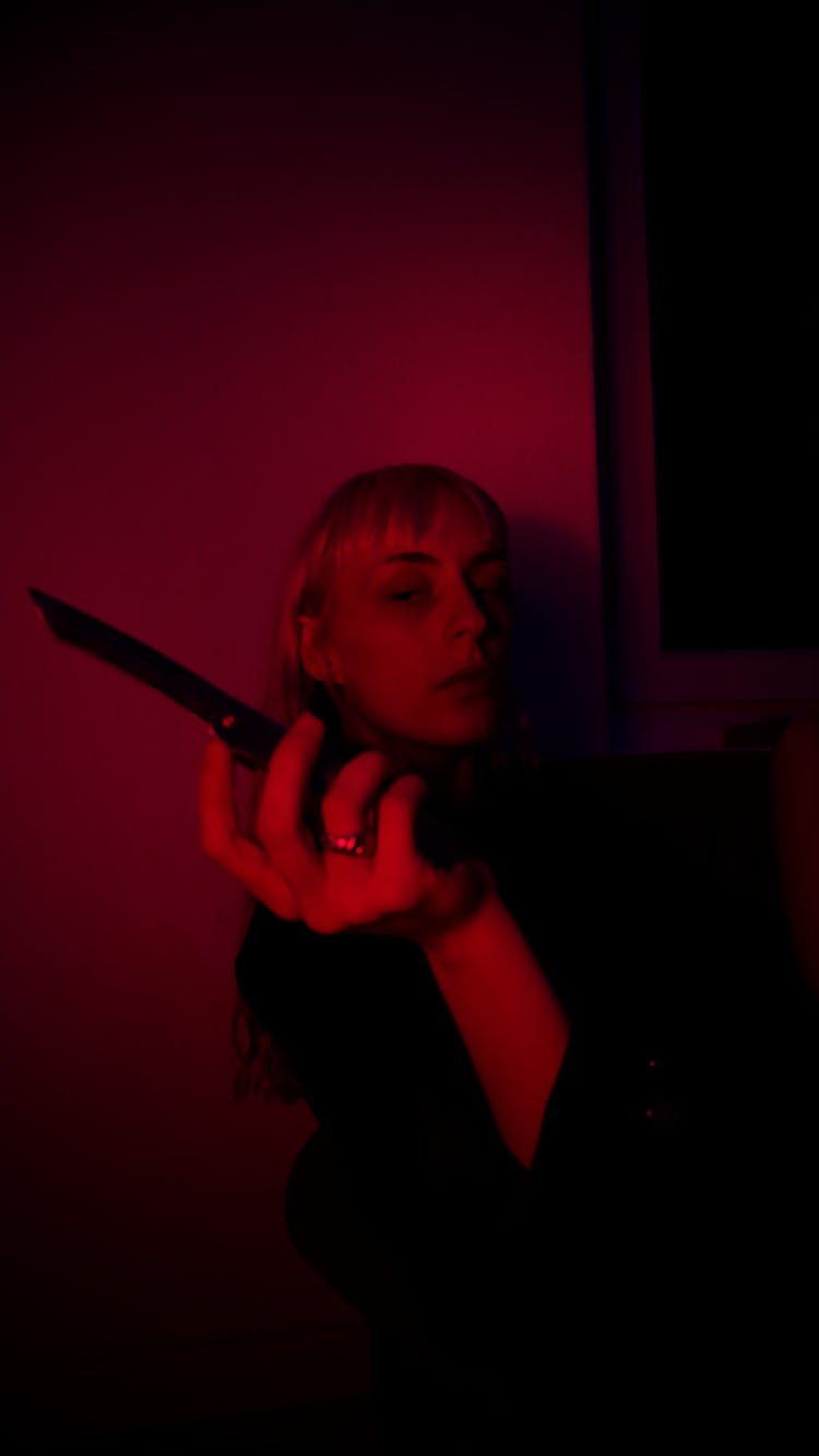 Woman With Knife In Dark Room