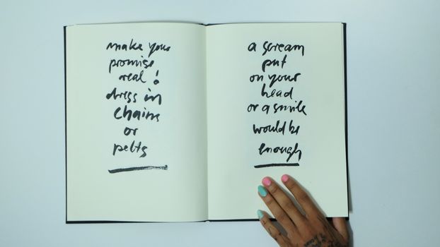 Crop faceless informal woman with opened notebook