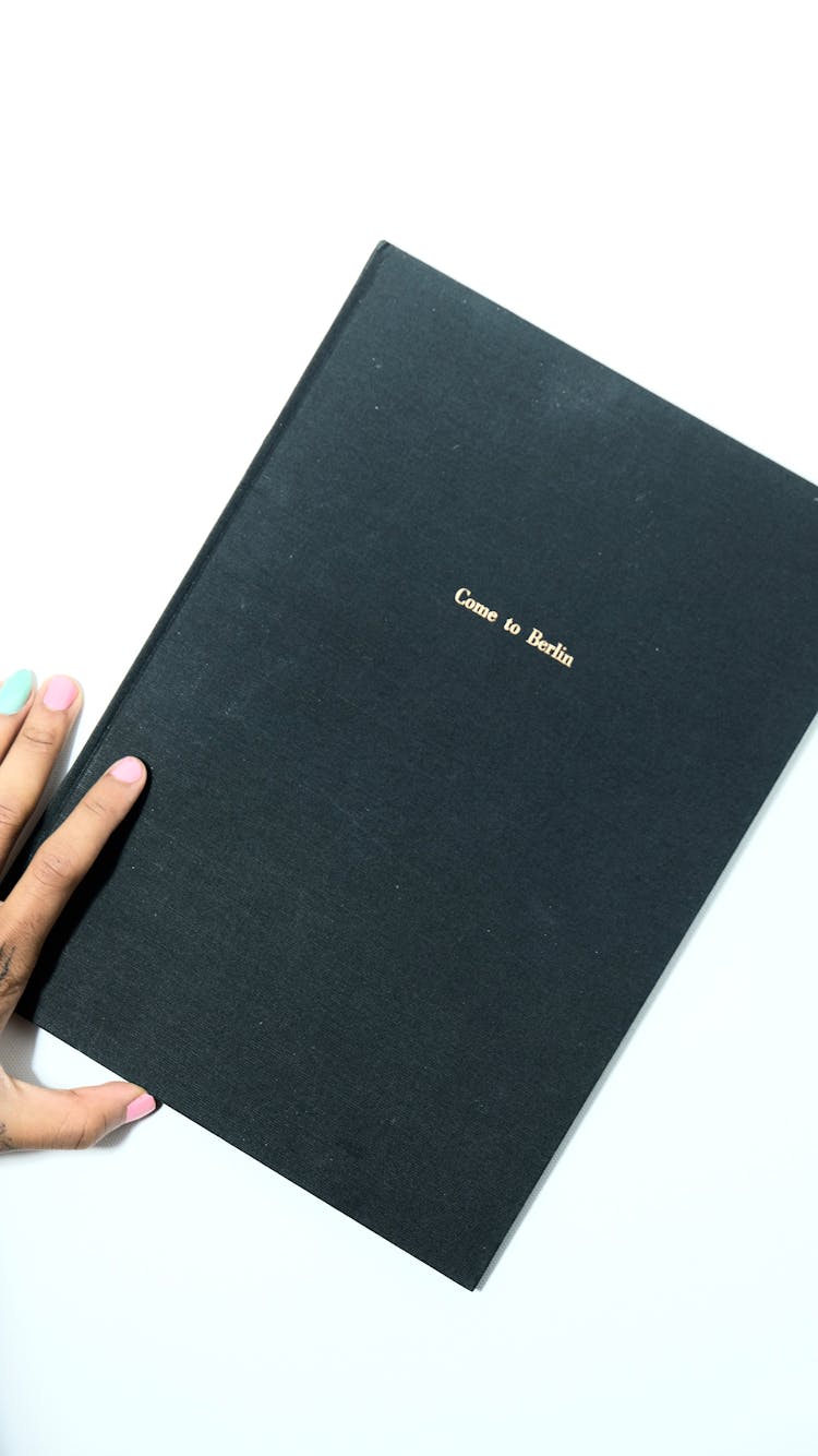 Unrecognizable Woman With Closed Book With Hardcover