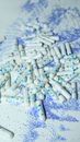 A pile of white tampons on a blue and white artistic background, indoors.