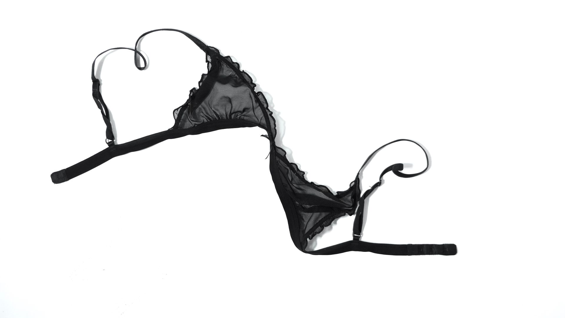 Single top bra piece of feminine lace black lingerie isolated on white background