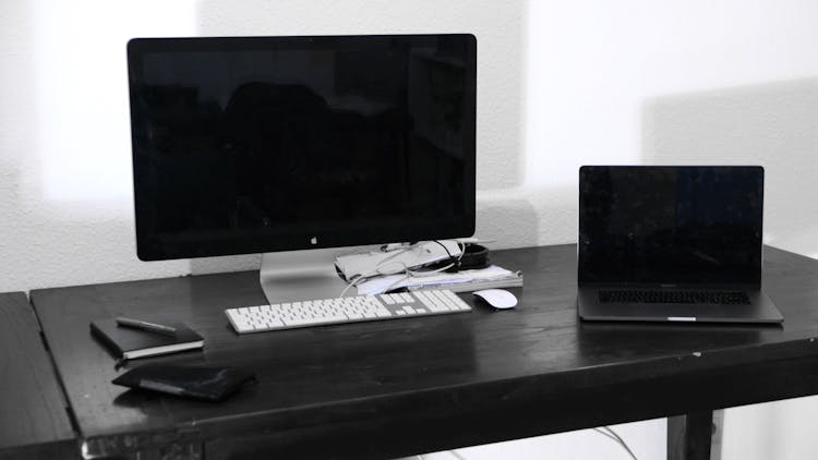 Modern Computer And Laptop On Table In Room