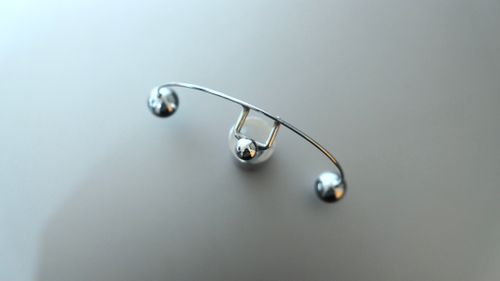 Free Top view of metal pendulum device placed on white table in psychiatrical clinic Stock Photo