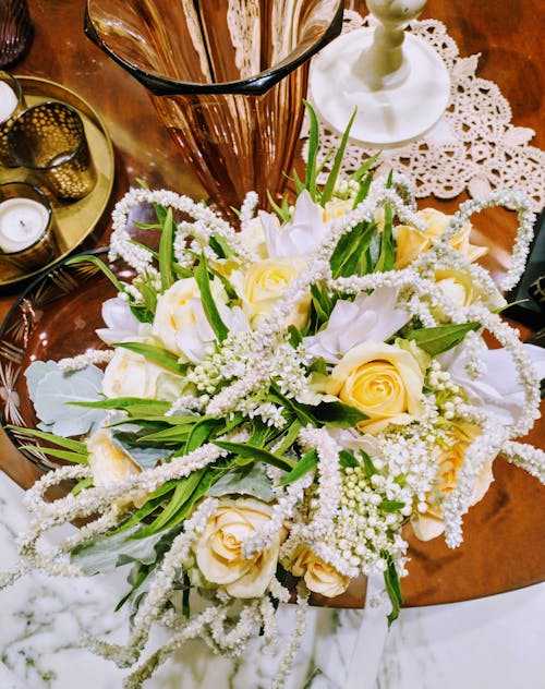 Free White and Yellow Flowers on Brown Wooden Table Stock Photo