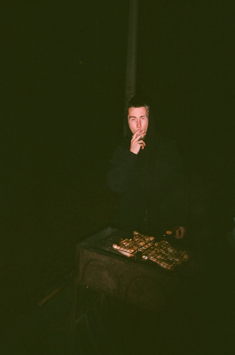 Man In Black Long Sleeve Shirt Smoking Cigarette