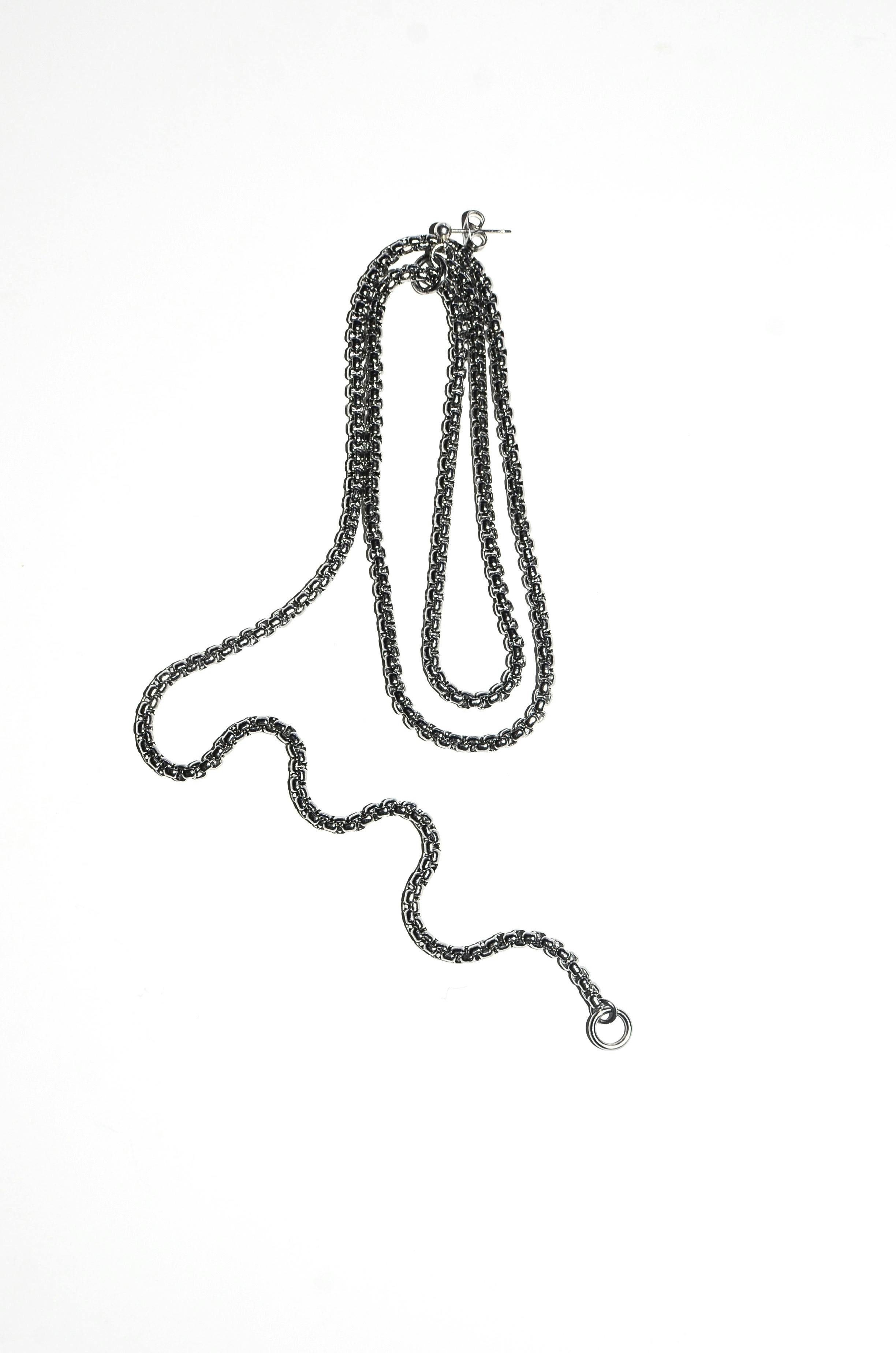 silver chain on light white surface