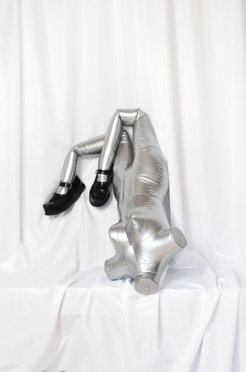 Inflammable Manique Inflatable mannequin with legs dressed in black boots · Free Stock Photo