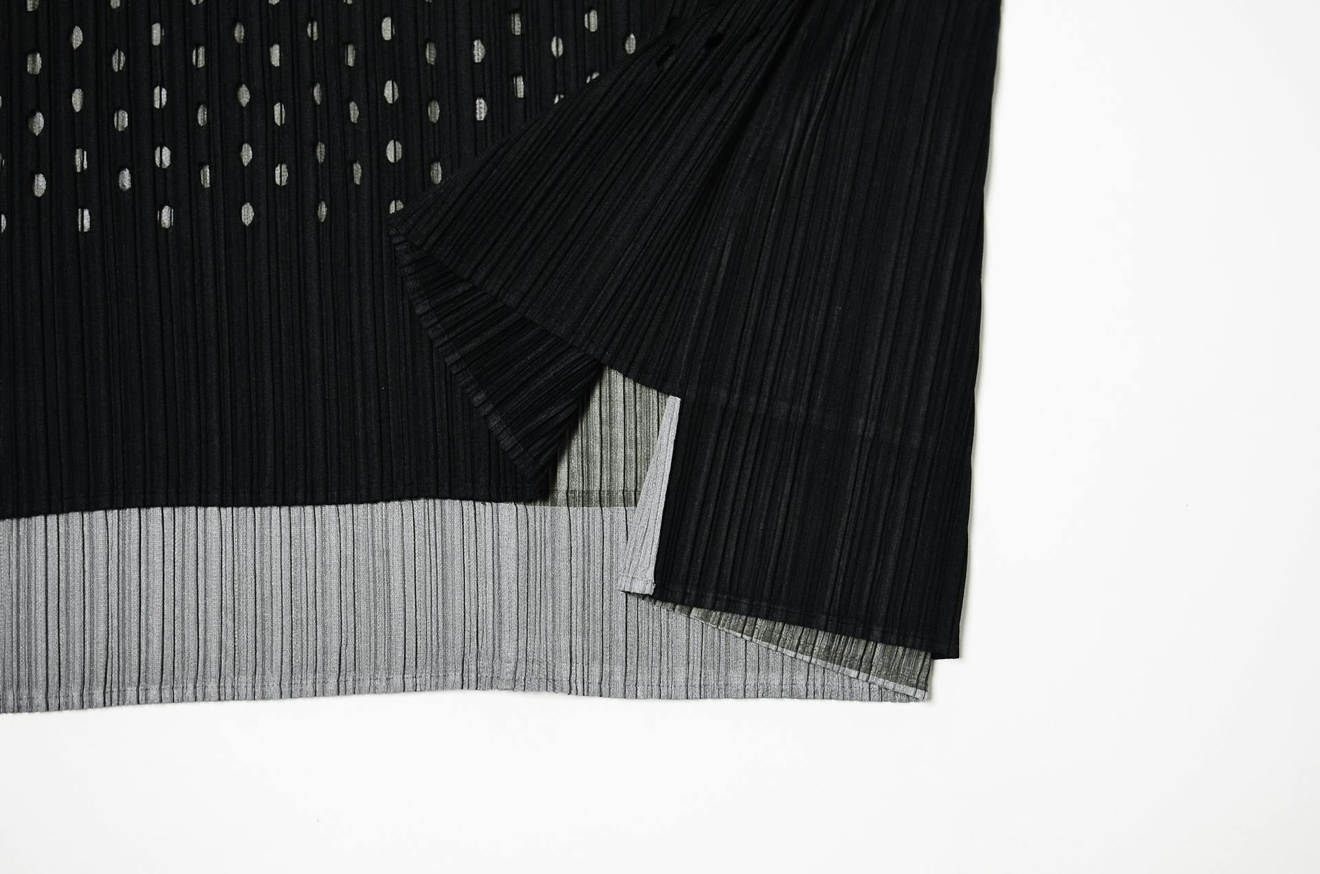 Part of stylish cloth with stripes and dots on white background in studio