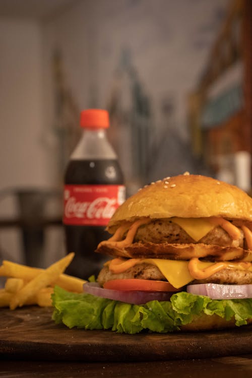 Hamburger and French Fried Near a Bottle of Coca Cola