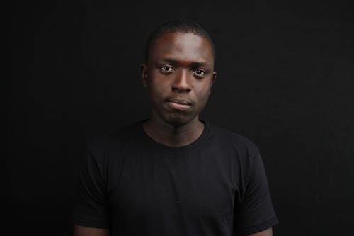 Close-Up Shot of a Man in Black Shirt