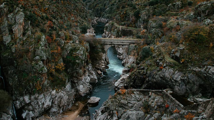 River Under A Bridge Connecting Rocky Mountains