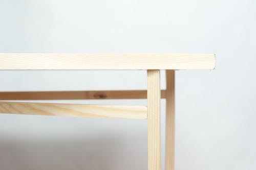 Free Wooden piece of furniture with flat top placed in minimal studio against white background Stock Photo