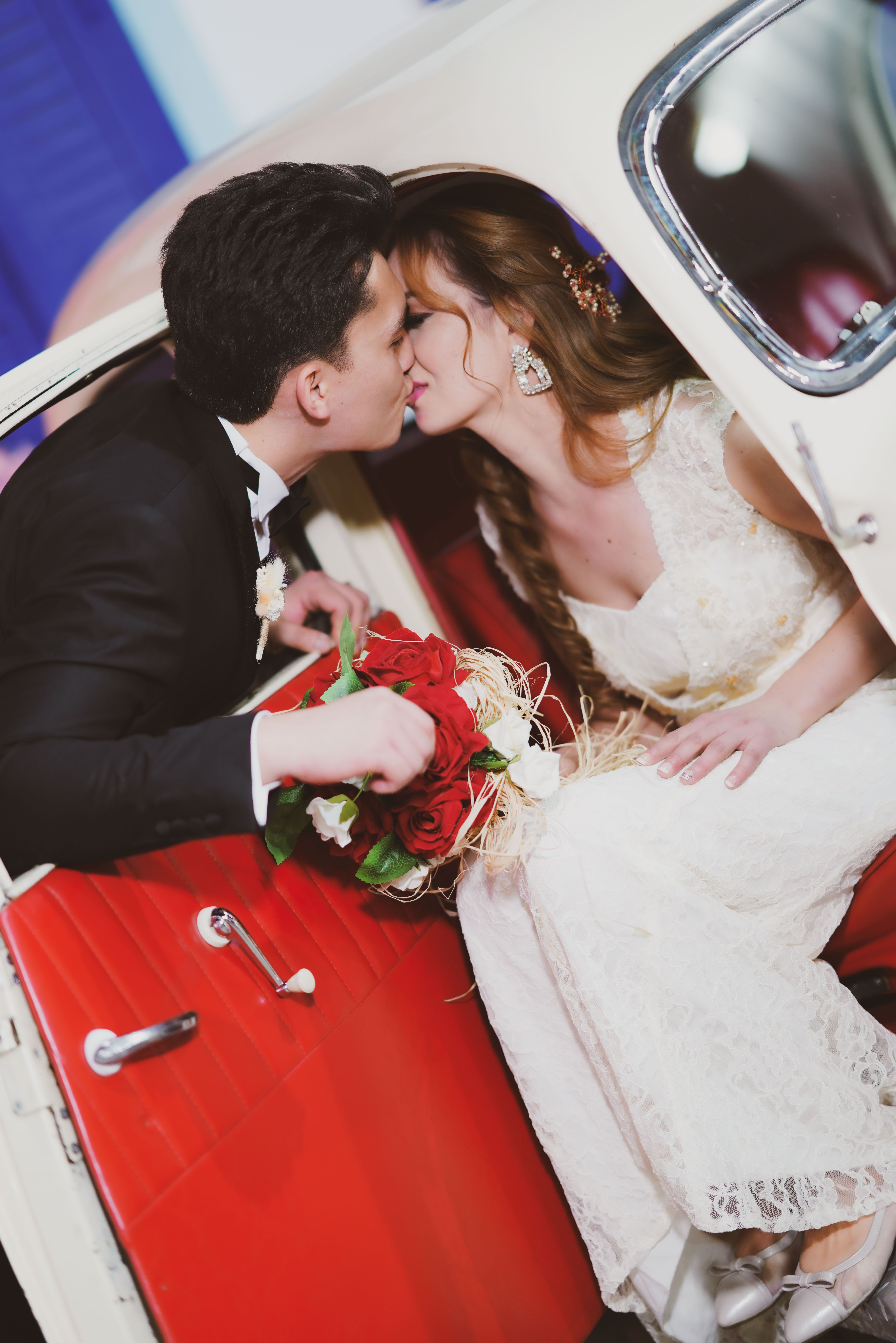 A Bride and a Groom Kissing in a Car · Free Stock Photo