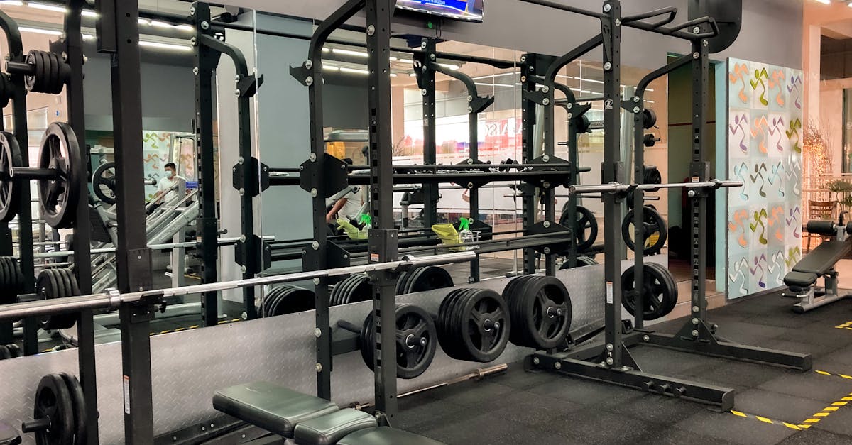 A spacious gym featuring benches, weights, and exercise machines for varied workouts. A spacious gym featuring benches, weights, and exercise machines for varied workouts.