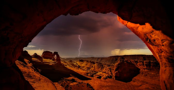 Captivating view of lightning above Arches National Park, framed by natural rock formations.