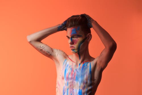 Free Topless Man Posing With Blue and Red Paint on His Body Stock Photo
