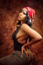 Woman in Black Tank Top and Red Floral Headdress