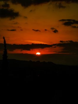 A stunning sunset with dramatic clouds and silhouette, capturing the beauty of the evening sky.