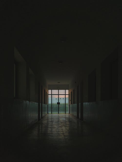 Free A Glass Door at the End of a Dark Hallway Stock Photo
