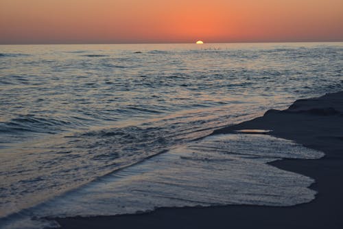 Ocean Waves Crashing on Shore during Sunset