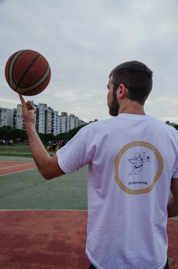 Man Spinning Basketball On Pointy Finger
